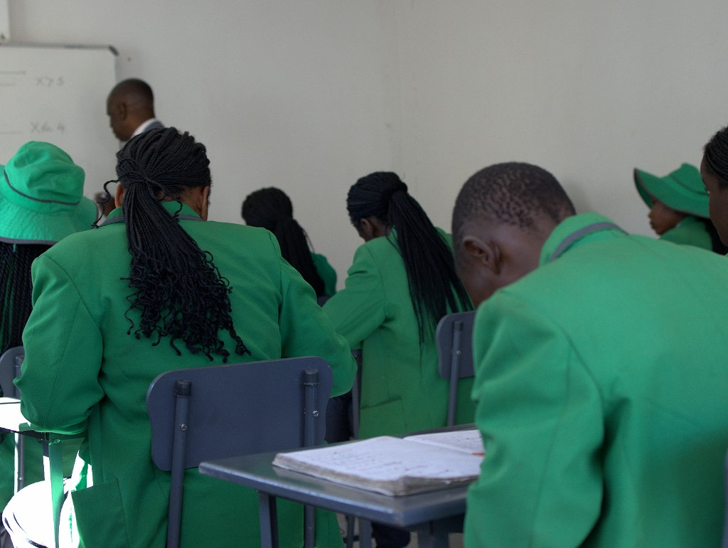 Sixth form classroom with pupils in green blazers